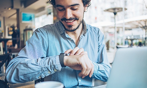 Man checking his watch before dental appointment