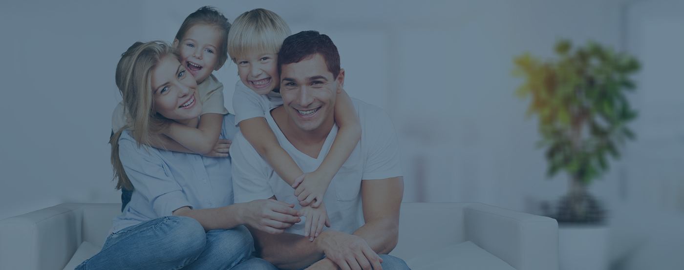 Mother father and two children smiling after dental office visit