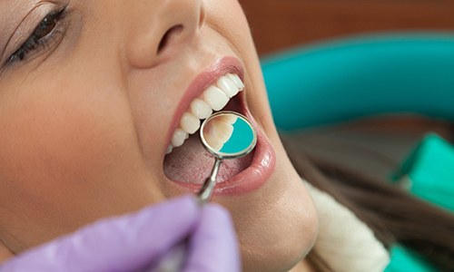 Dentist examining patient's metal free dental restoration