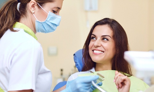 Patient smiling at Webster dentist during dental crown visit