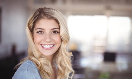 Woman with dental crown in Webster smiling