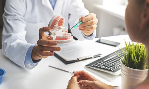 a patient talking with their dentist