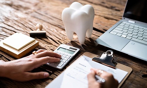 a patient filling out a dental insurance form