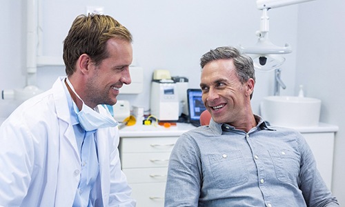 Emergency dentist in Webster and patient talking