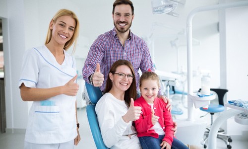 smiling family visiting a Webster family dentist