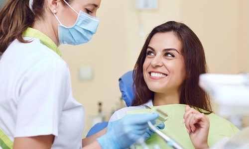 Woman smiling after getting a tooth-colored filling in Webster