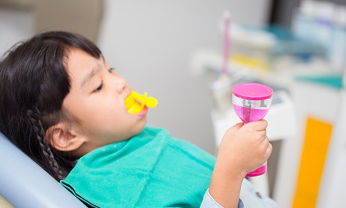 Child receiving fluoride treatment