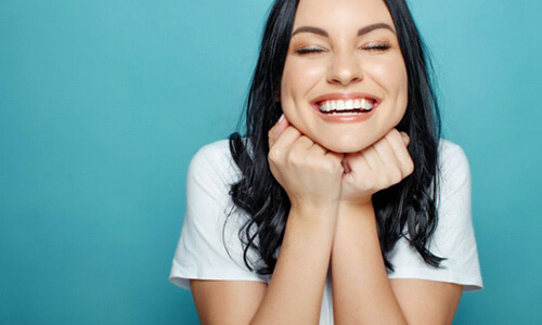 Woman smiling after teeth whitening in Webster