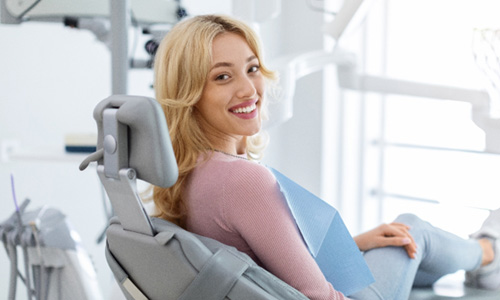 Happy dental patient looking over her shoulder