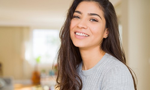 Woman smiling after teeth whitening in Webster