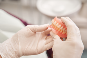 a dentist holding dentures